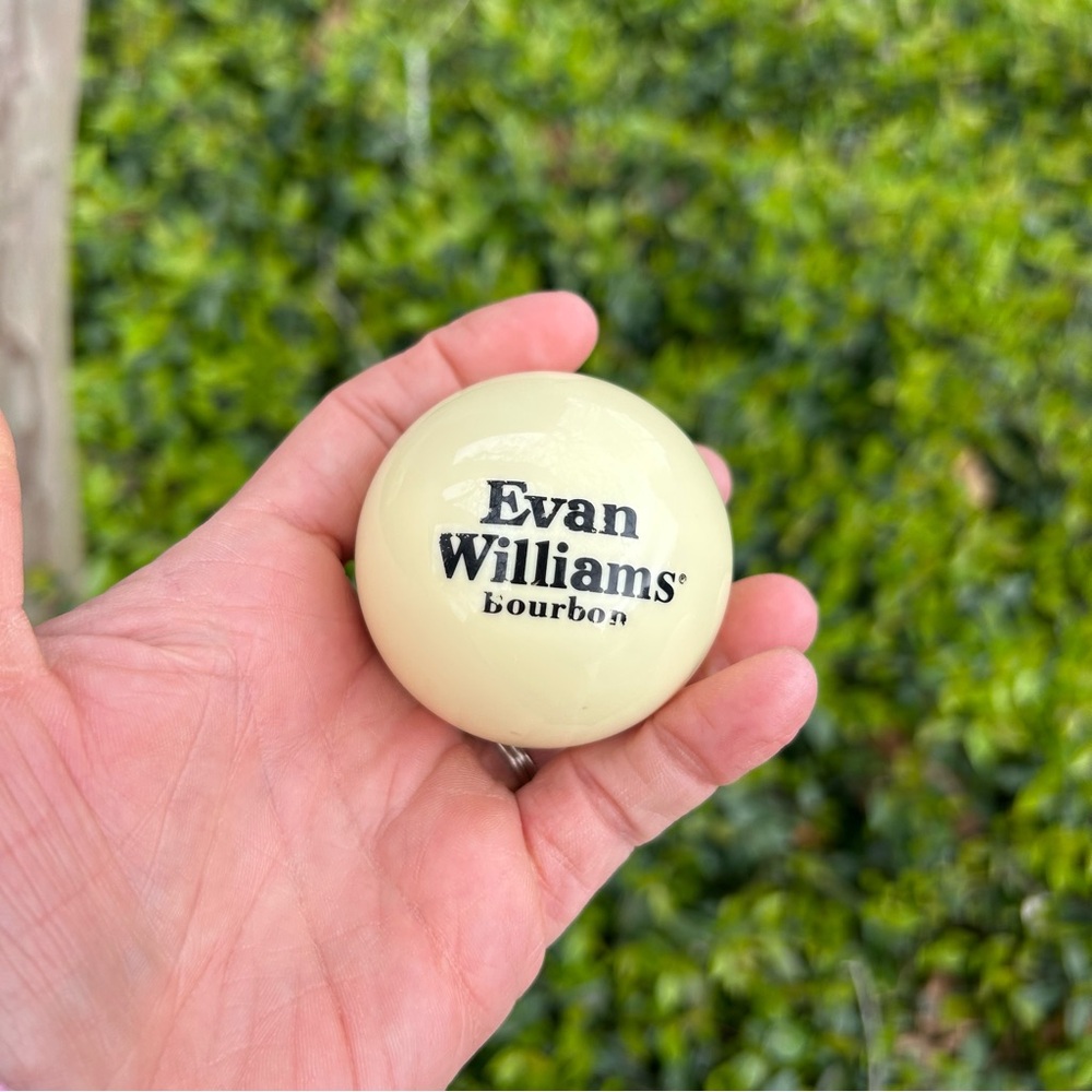 custom-branded cue ball featuring the Evan Williams Bourbon logo.